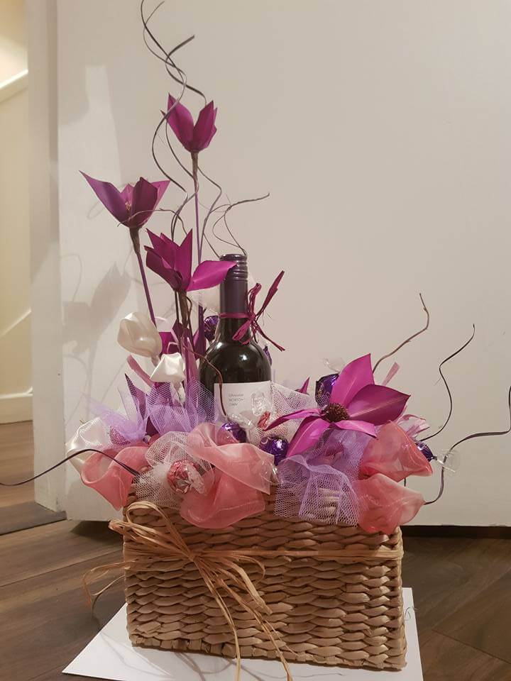 wine gift basket with artificial flower and candy